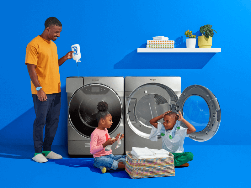 Family in laundry room doing laundry
