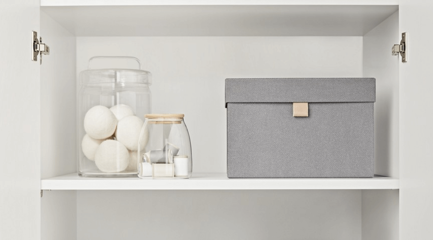 A neatly organized laundry room cabinets.