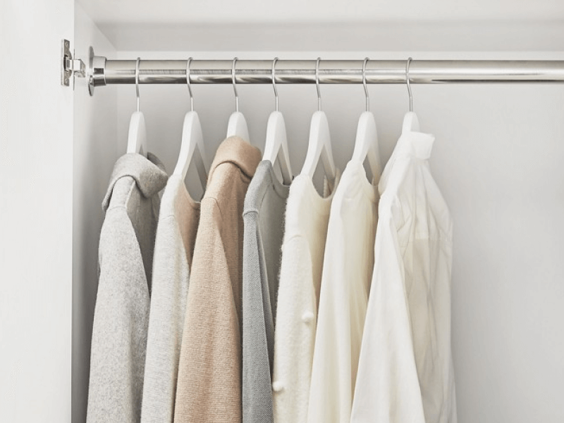 A cabinet in a laundry room with hanging space to dry and organize your clothes.